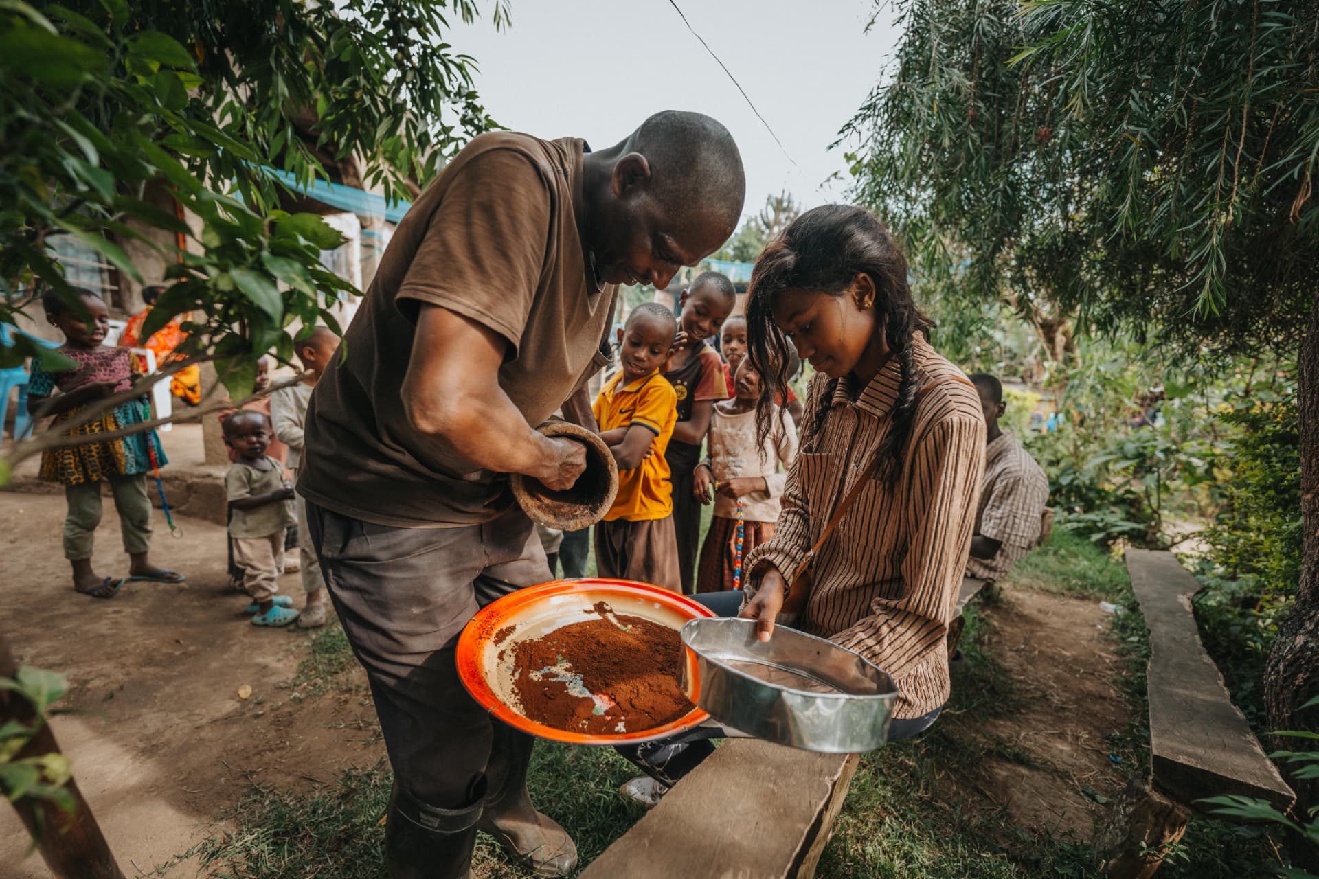 A local farmer inspecting coffee beans on a large tray