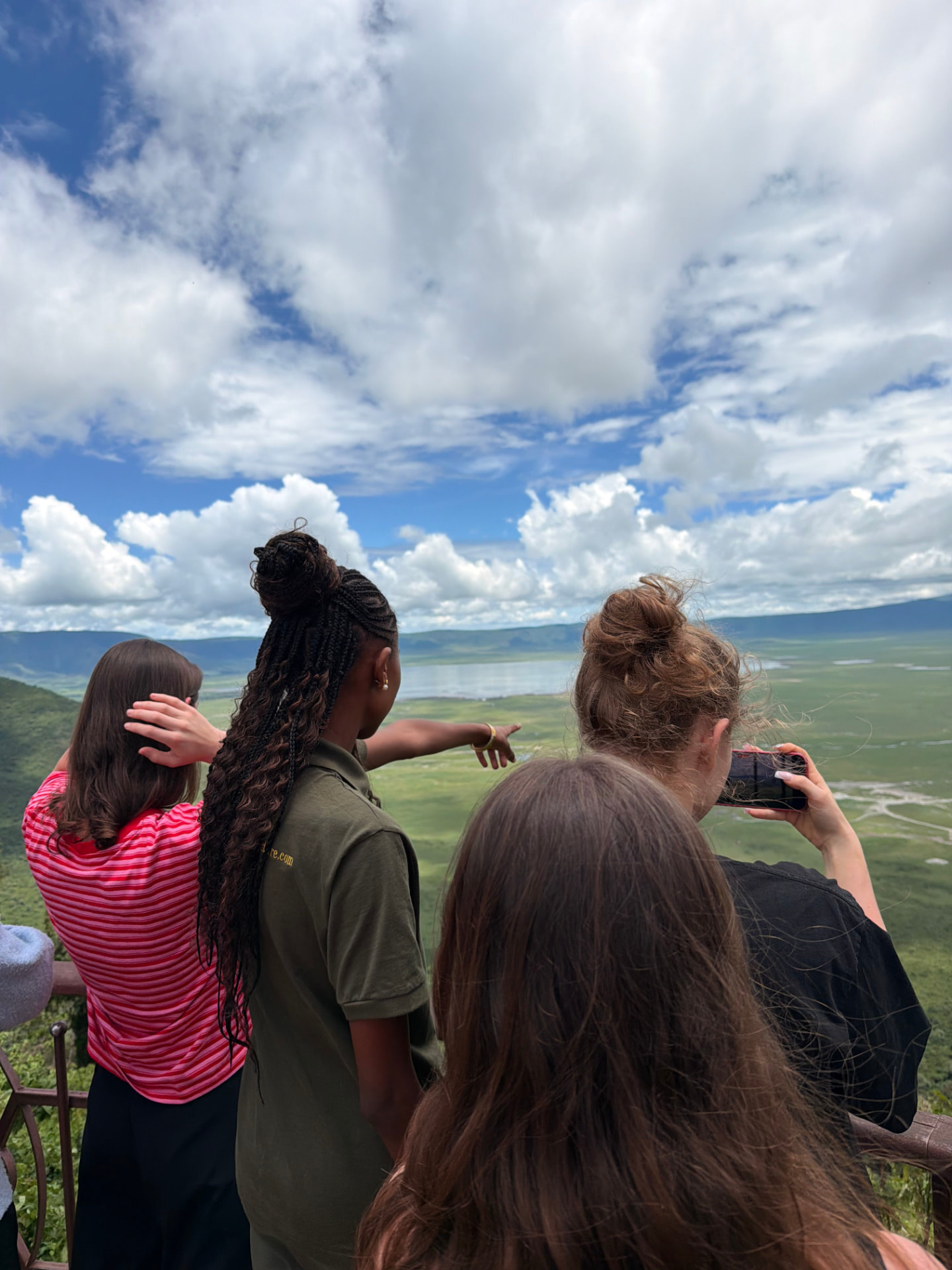 A guide pointing out the crater floor to guests from the Ngorongoro viewpoint