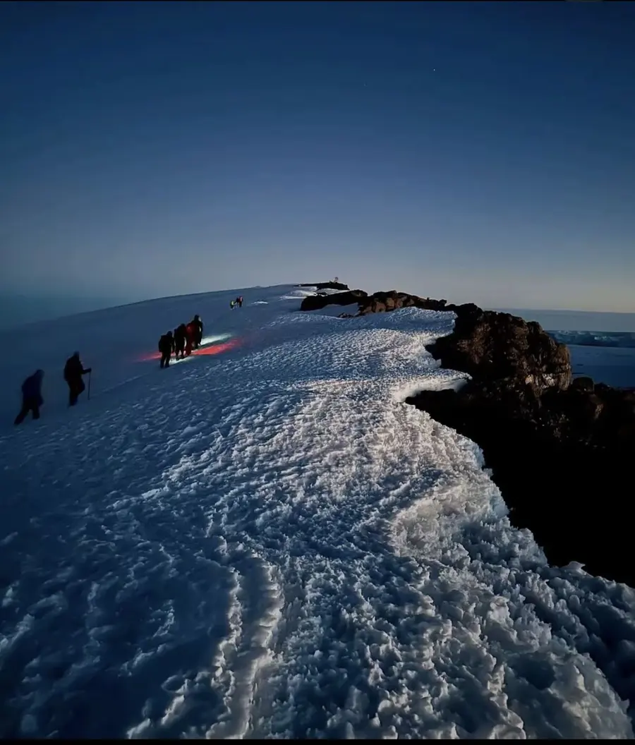 Kilimanjaro's snow-capped summit rising above the clouds