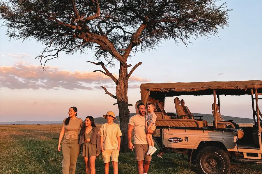 A family watching wildlife together from a safari vehicle