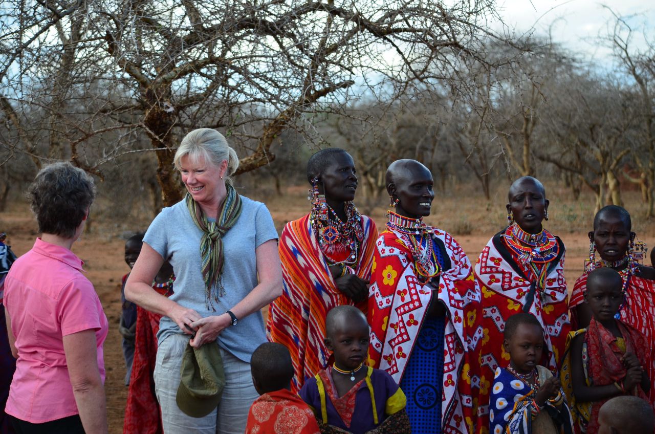 Guests talking with Maasai families and children in the village