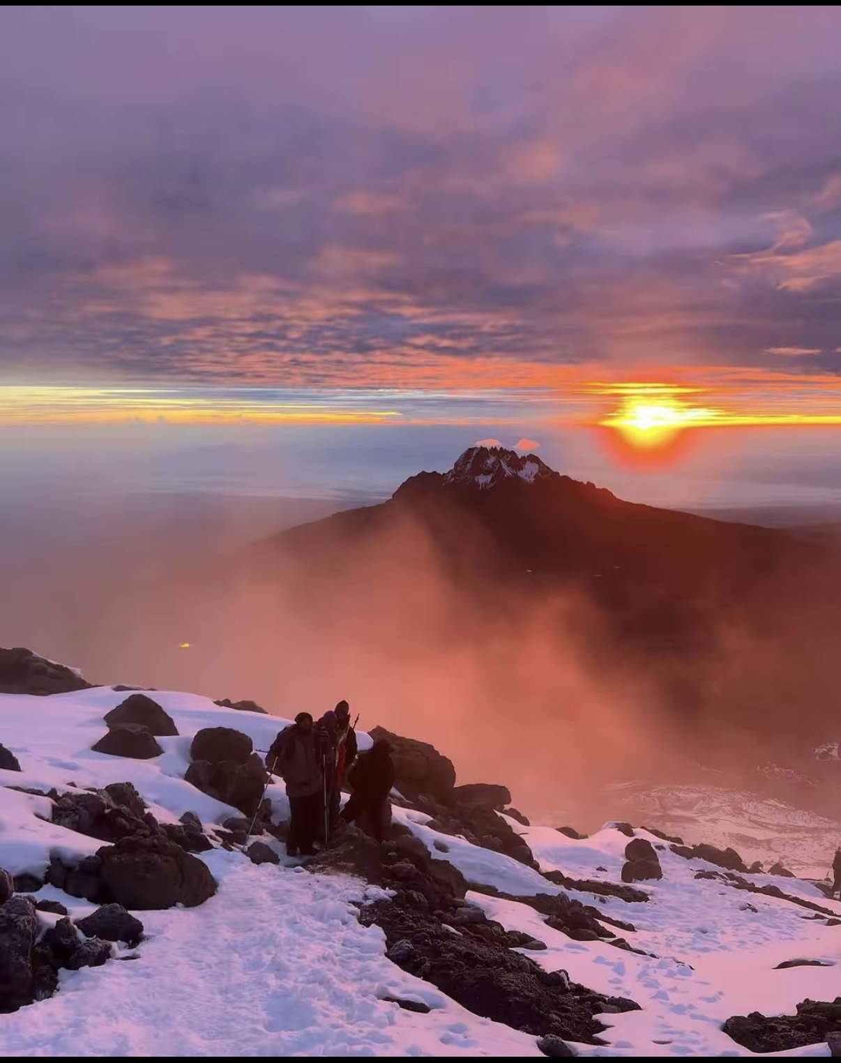 Mount Kilimanjaro rising above the clouds at sunrise